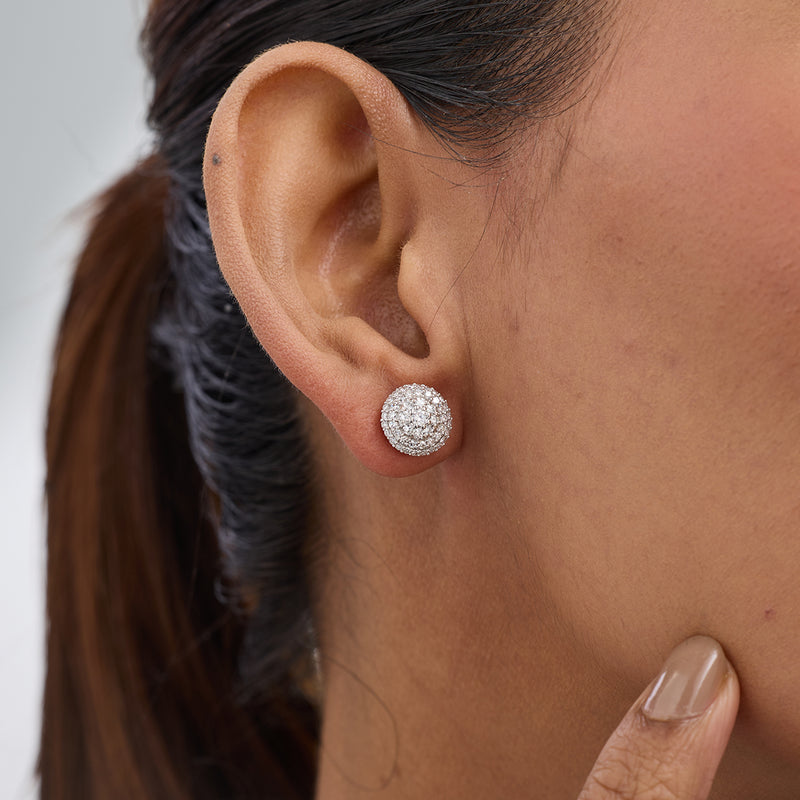 A woman wears Keemti Jewels' Floral Aura Diamond Stud Earrings, her hand gently touching her jaw.