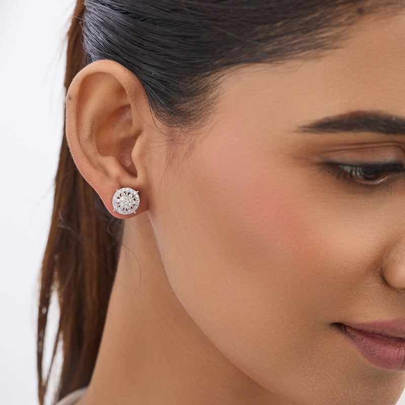 A woman with smooth skin and straight hair wears Keemti Jewels Blooming Bush Halo Diamond Stud Earrings.