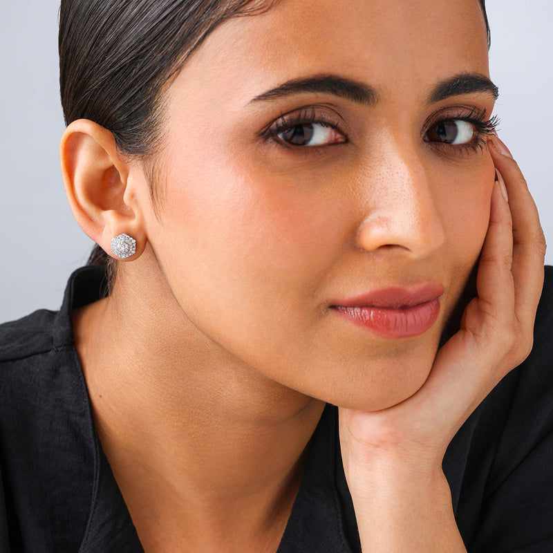 Woman with smooth skin wears Keemti Jewels' Hexa Cluster Diamond Stud Earrings, gazing at the camera in a black top.