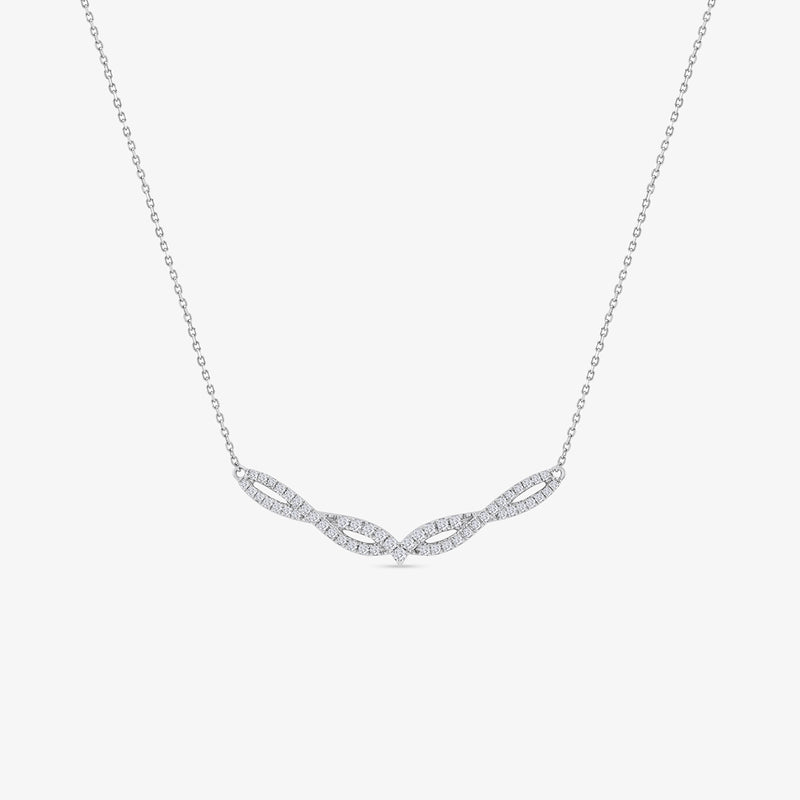 The Luna Chevron Diamond Necklet by Keemti Jewels features a twisted diamond pendant on a fine chain, elegantly displayed.