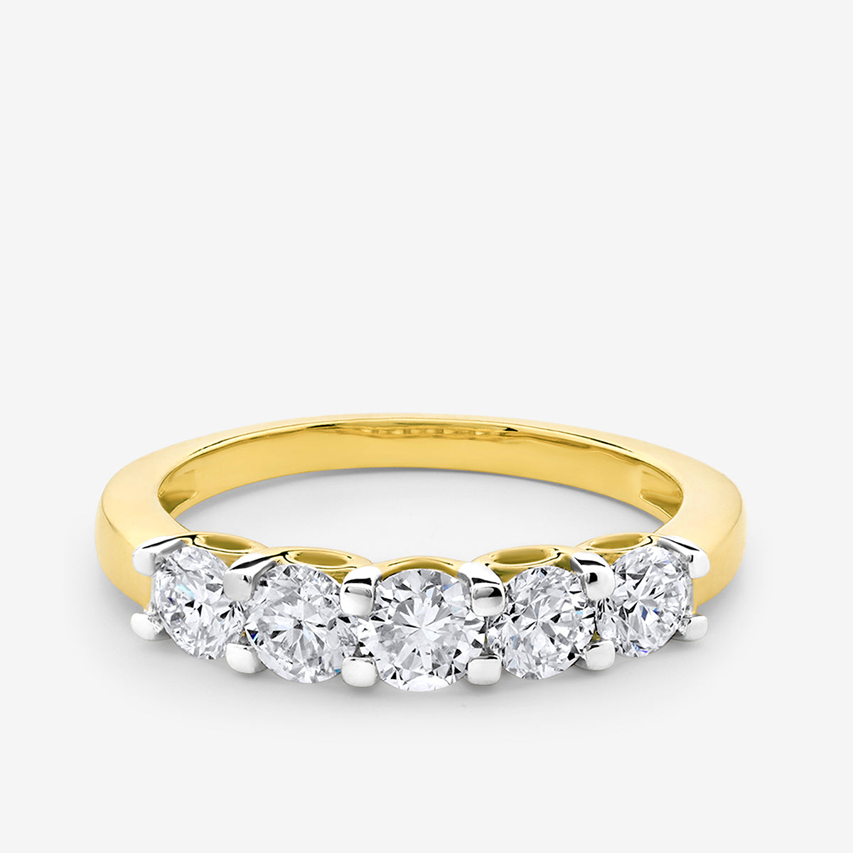 The CROWN Arc Solitaire Ring by Keemti Jewels features five round diamonds set in gold with an arched top.