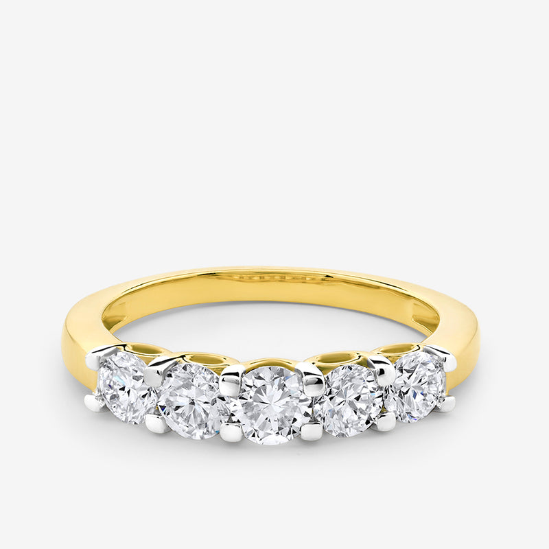 The CROWN Arc Solitaire Ring by Keemti Jewels features five round diamonds set in gold with an arched top.