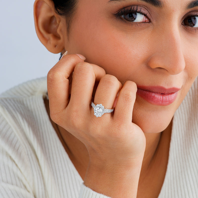 A woman in a white top smiles, showcasing Keemti Jewels' Royal Bloom Diamond Bridal Ring on her left hand.