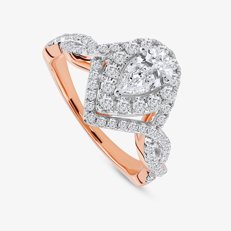 Keemti Jewels’ Rose Dewdrop Diamond Bridal Ring features a pear diamond, double halo, and twisted pink band with diamonds.