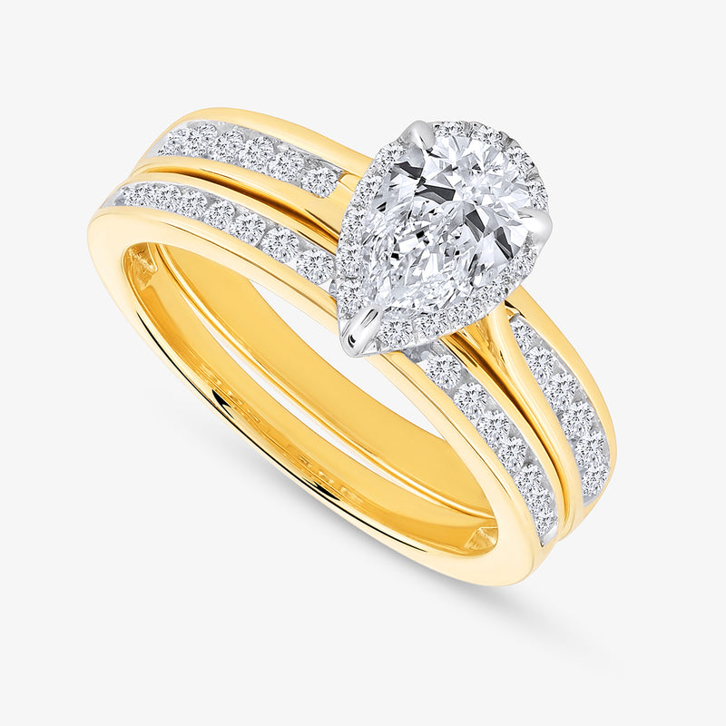 Keemti Jewels’ Soft Glow Pear Diamond Solitaire Ring features a gold band with a pear-cut diamond and sparkling accents.