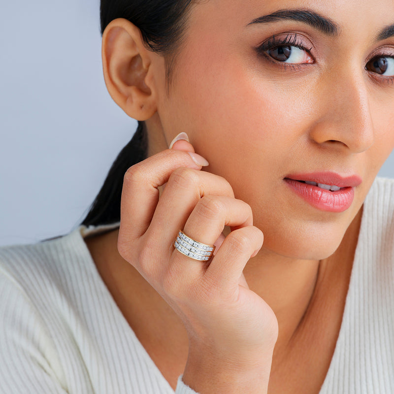 A woman in a white top models Keemti Jewels' Orbit Radiance Diamond Ring, perfect for everyday style.